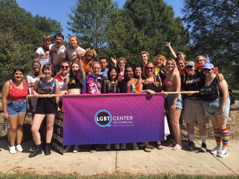 LGTBQ+ Center students standing with sign at pride parade